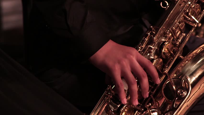 A man's hand in a black suit on a gold saxophone in a jazz band. Close-up. Royalty-Free Stock Footage #32738080
