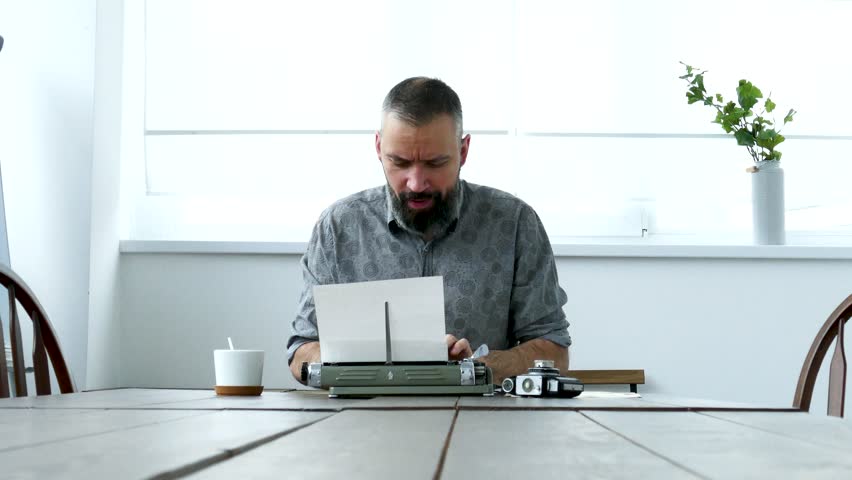 Writer at work having strong emotions about text