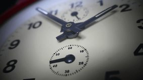 Close up footage of an old clock and its seconds hand clicking...