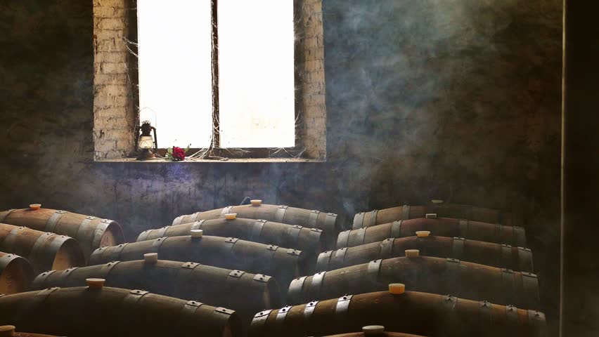 Moody Scene of Wine Cellar featuring barrels with misty haze floating in air