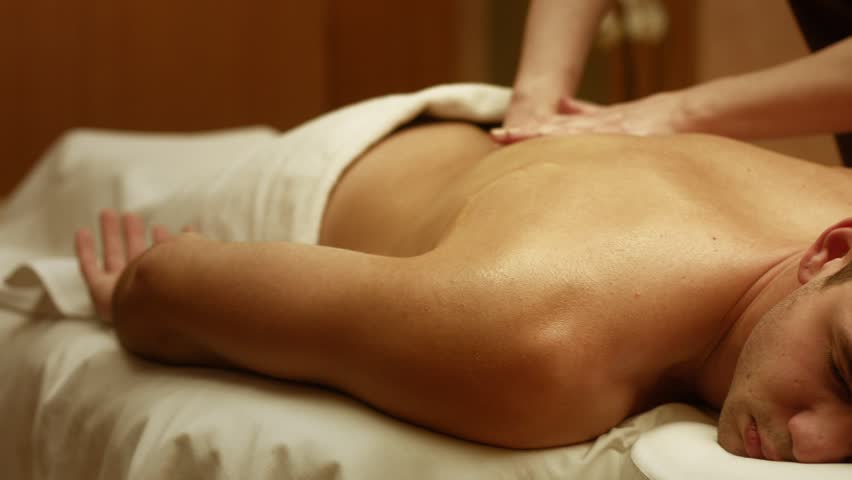 Shot of a professional masseuse massaging back and shoulders of a male client. Man receiving full body massage at spa relaxing rest wellness resort wellbeing pampering enjoying occupation service Royalty-Free Stock Footage #32748043