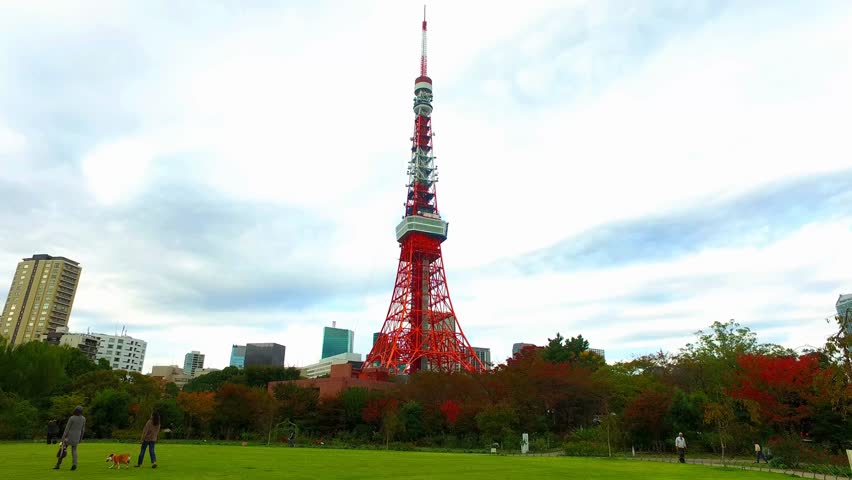 Side tracking shot of Tokyo tower from Shiba-koen park Tokyo Japan.