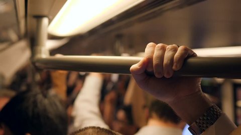 Business Man's Hand Holds on to the Rail Hanger in the Subway Train. 4K. Bangkok, Thailand.