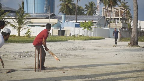 MAAFUSHI. MALDIVES - CIRCA DEC 2016: Abstract of locals playing cricket in slow motion on Maafushi Island. FullHD footage