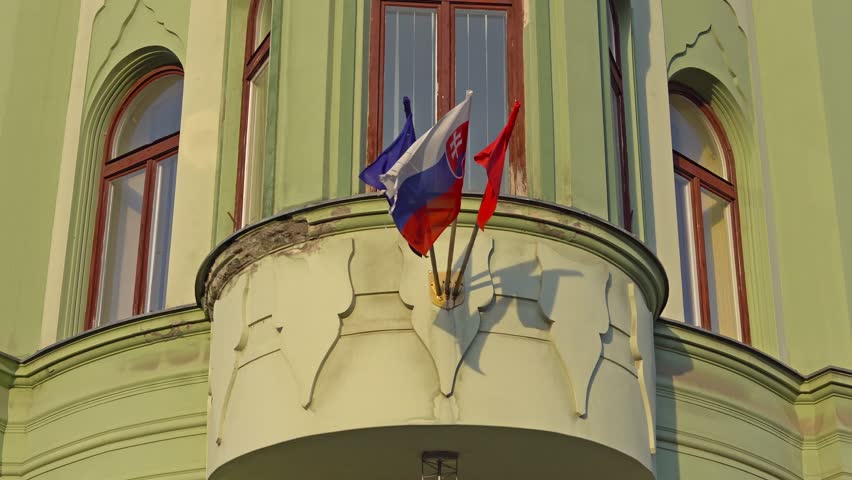 BRATISLAVA, SLOVAKIA - November 2013: the Slovak and european flags waving in Bratislava. Bratislava is occupying both banks of the River Danube and River Morava.