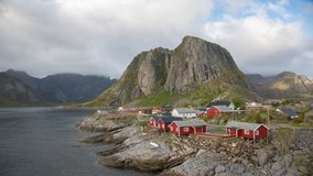 Moving clouds timelapse over traditional Norwegian fisherman's cabins, rorbuer, on the island of Hamnoy, Reine, Lofoten islands, Norway.