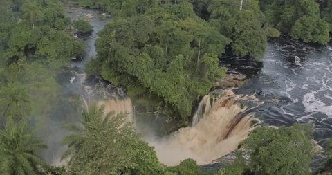 Aerial large circular double epic waterfalls river inside the equatorial green jungle in Africa Gabon 2015
