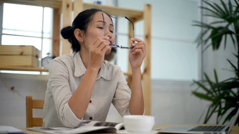 Asian woman feeling stress from work in the office.