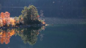 Splendid autumn scene of Eibsee lake. Colorful morning view of small island on bottom of the Zugspitze peak, Bavaria, Germany, Europe. Full HD video (High Definition).