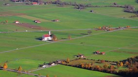 Time lapse clip. Aerial autumn view of St. Coloman Catholic Church in Fussen Germany. Sunny morning scene in Bavarian Alps, Germany, Europe. Full HD video (High Definition).