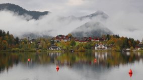 Time lapse clip. Foggy autumn scene of Grundlsee lake. Amazing morning scene of Brauhof village, Styria stare of Austria, Europe. Colorful view of Alps. Full HD video (High Definition).
