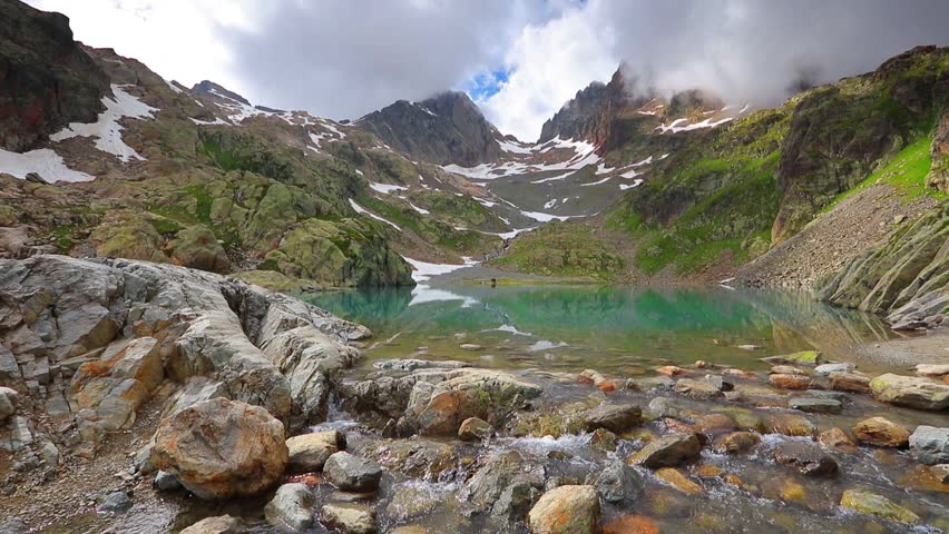Misty summer morning on the Lac Blanc lake with Belvedere peak on background, Chamonix location. Beautiful outdoor scene in Graian Alps, France, Europe. Full HD video (High Definition).
