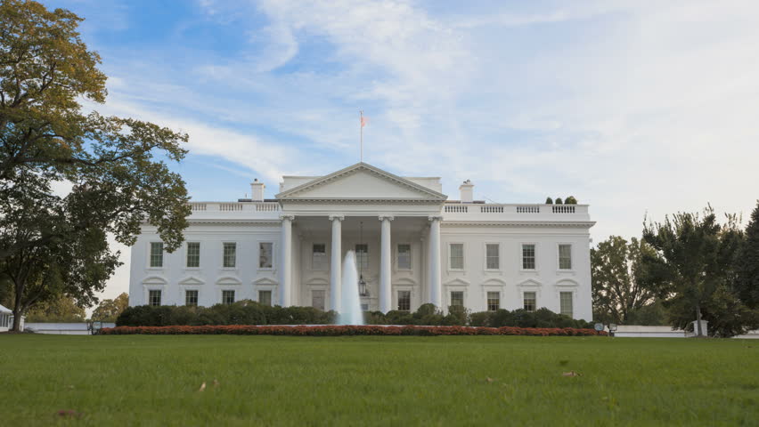 Time lapse of the White House at sunset with a blue sky and twilight unitl it