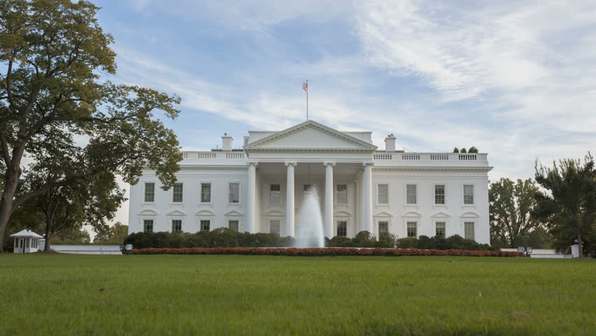 Time lapse of the White House at Daytime with a blue sky and clouds passing by