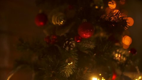 New Year 2020. New Year, new year, light background. New Year mood, Christmas tree, Christmas tree toys. Lights, bokeh. Room, fireplace, Christmas tree, log, Yellow light, red lights. Merry Christmas 