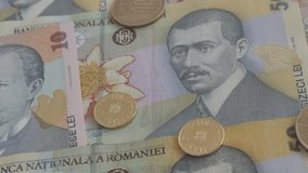 Slow tilt on Romanian national currency 3840X2160p 30fps UltraHD    video - Coins and paper banknotes of Romania 4K 2160p UHD tilting footage