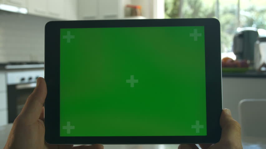 Tablet held by hands. Green screen Chroma Key. Close up. Tracking motion. Vertical. POV, modern kitchen, day, Swipe left / right animation.