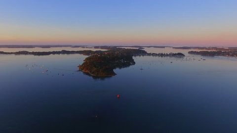 Flying over the Monks'
s island at sunrise, located in the famous Gulf of Morbihan, Brittany, France. It also known as "the pearl of the Gulf". This Gulf is one of the world's most beautiful bays. 