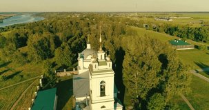 Drone video. Journey through the Golden Ring. Konstantinovo village, the birthplace of the famous Russian sweat Sergei Yesenin. Orthodox cathedral, green meadows and a Oka river bend. Russia. Spring 2