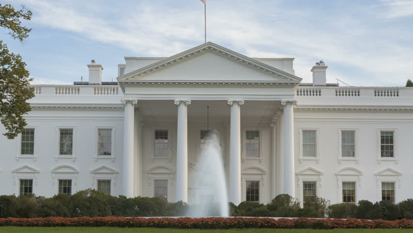 Time lapse of the White House at Daytime with a blue sky and clouds passing by