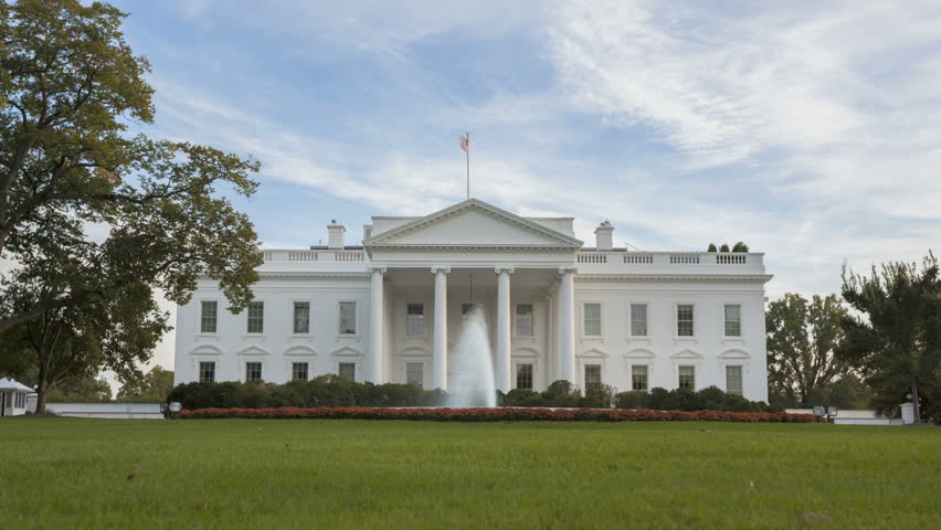 Time lapse of the White House at Daytime with a blue sky and clouds passing by