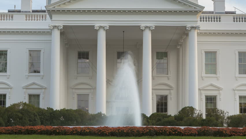 Time lapse of the White House at Daytime with a blue sky and clouds passing by