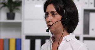Woman with Headset Talking on Voice Calls with Customer in Call Center Office