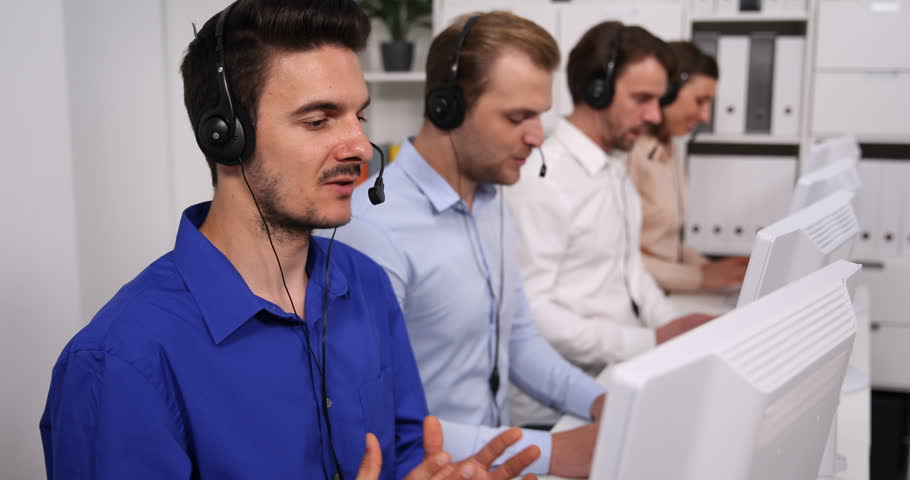 Friendly Mixed Ethnicity Telesales Group Taking Calls in a Corporate Call Centre Royalty-Free Stock Footage #32807113
