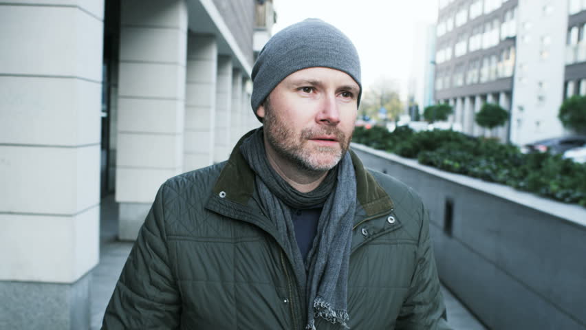 Middle-Aged Man Lighting a Cigarette in the Street