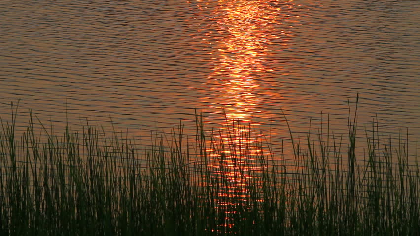 Sunset above gloomy spring river. 