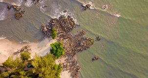 Seascape aerial footage of beach and rocks