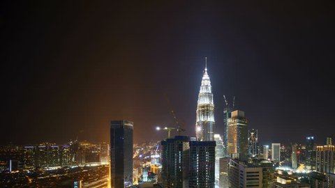 4k time lapse of night to day sunrise scene at Kuala Lumpur city. Sunrise from the horizon line. Aerial view. Tilt down