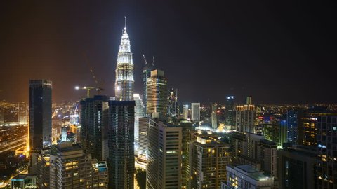 4k time lapse of night to day sunrise scene at Kuala Lumpur city. Sunrise from the horizon line. Aerial view. Pan left