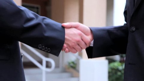 Handshake - Businessmen shaking hands business deal partnership high definition. CloseUp