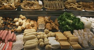 Variety of delicious foods. including sausages. dimsum. broccoli and more. at a popular Chinese buffet restaurant in Singapore. 4k DCI footage