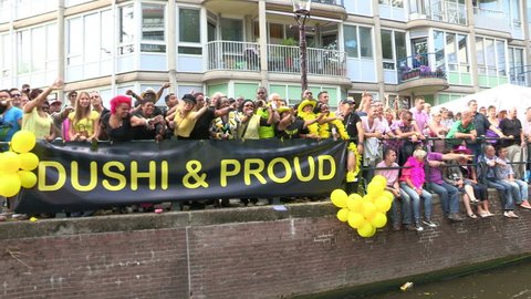AMSTERDAM, HOLLAND - AUGUST 4: Gay Pride Canal Parade Amsterdam 2012 filmed from one of the parading boats - August 4, 2012 in Amsterdam, the Netherlands.