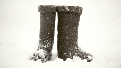 Winter boots on a snowy background