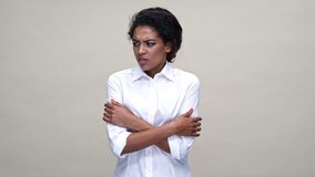 Young african woman in shirt having cold over gray background