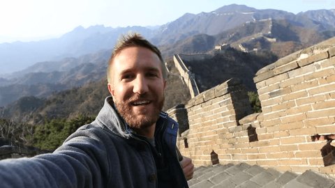 Man travelling in China takes selfie on top of the Great Wall of China.
Selfie point of view man travelling in China 