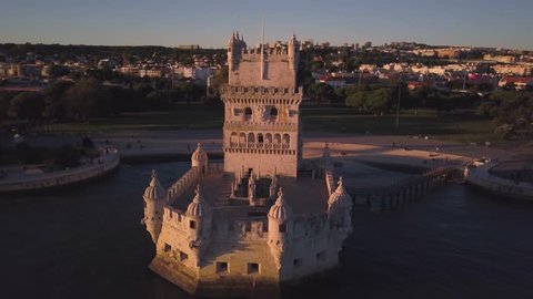 The Belem Tower at sunset.  4k aerial drone footage of a medieval fortress that defended the city of Lisbon (Lisboa) Portugal.