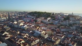 4k aerial drone footage over the city of Lisbon, Portugal.  Seen is the famous medieval Fernandina Wall, the orange roofs of the Alfama District, and the famous Commerce Square.
