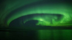 Brilliant wide aurora borealis reflecting over calm ocean  - Powered by Shutterstock - Get 15% off with code: PIKWIZARD15
