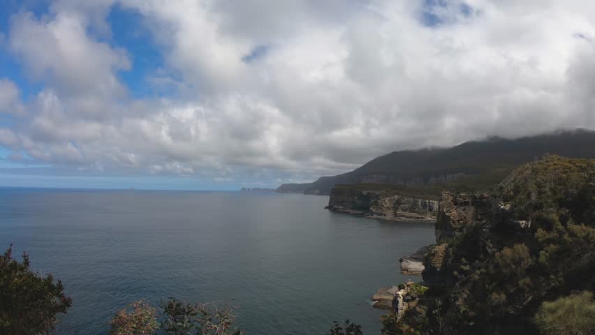 View of mountains, ocean and coast, from the Tasman Arch Lookout, on a bright sunny day, Tasmania, Australia 