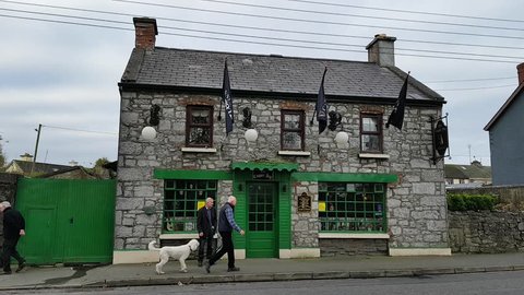 Ennis, Ireland - Nov 17th, 2017: Old man outside a rural  Irish traditional Pub in County Clare, Ireland