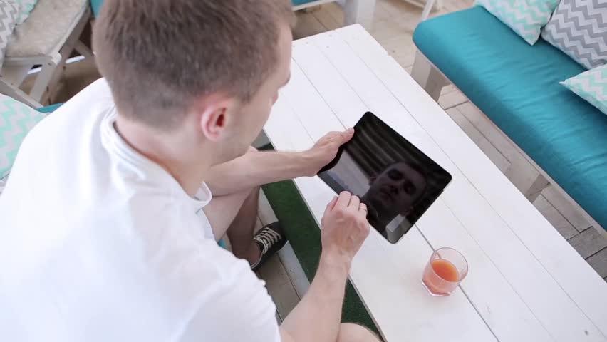 Young Man Working On a Tablet  And Drinks Juice  | Shutterstock HD Video #32871874