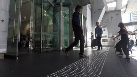 Sydney, Australia circa October 2017, business people walking through revolving doors in Sydney's financial district