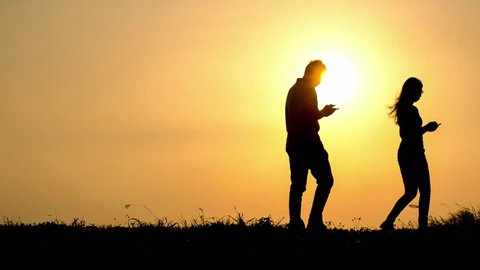 silhouette of woman and man use smart phone