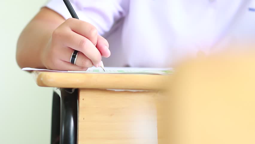 Students holding pencil eraser while taking exams, examination room, writing answer optical form in high school classroom, view of having test in class on seat rows, Education literacy concept. Royalty-Free Stock Footage #32883727