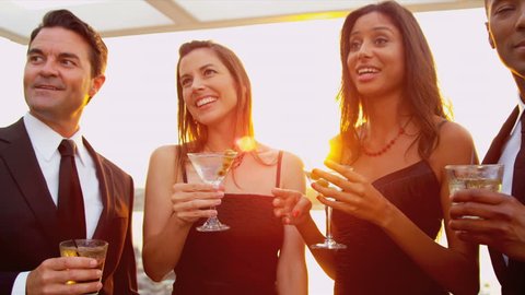 Diverse attractive couples dating at luxury rooftop cocktail party