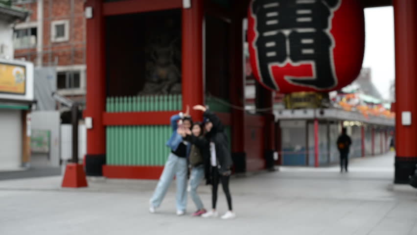 Happy couple hugging at front gate of Senso-ji temple